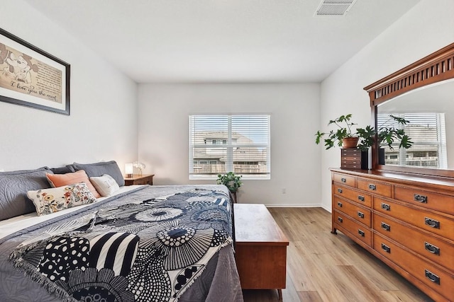 bedroom with multiple windows and light wood-type flooring