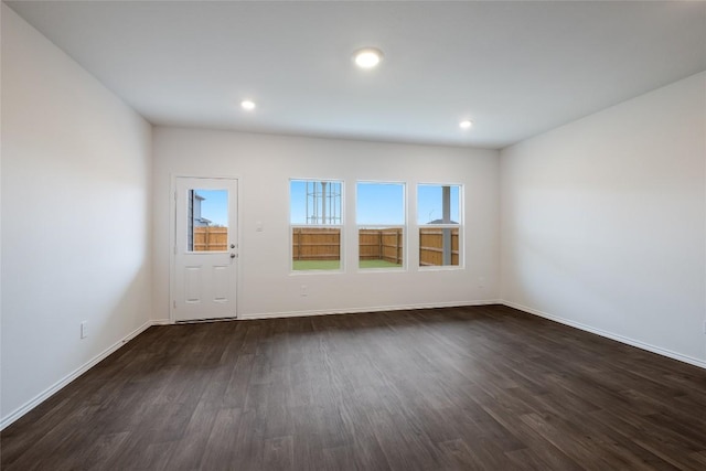 interior space featuring recessed lighting, dark wood finished floors, and baseboards