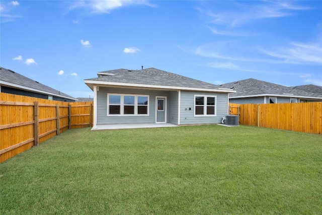 rear view of property featuring a patio, cooling unit, a fenced backyard, a lawn, and roof with shingles