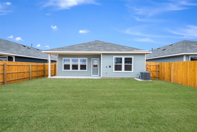 back of house featuring a fenced backyard, a yard, a patio, and central AC unit