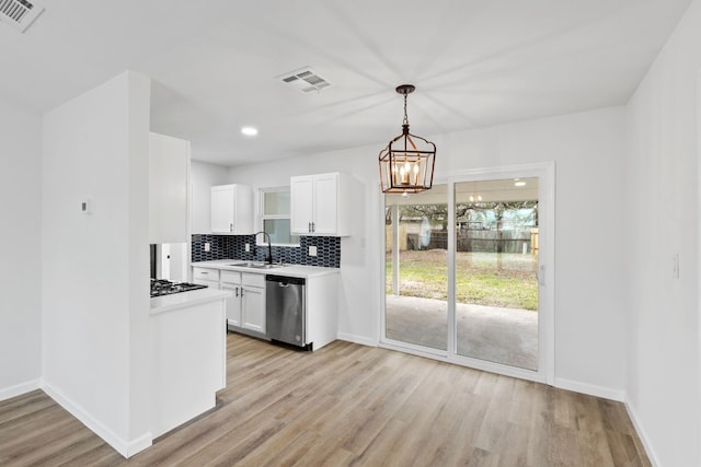 kitchen featuring backsplash, stainless steel appliances, light hardwood / wood-style flooring, and white cabinets