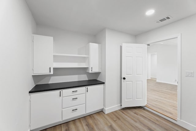 kitchen with white cabinetry and light wood-type flooring