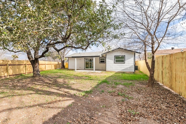 back of property featuring a lawn