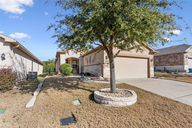 view of front of home with a garage and central air condition unit