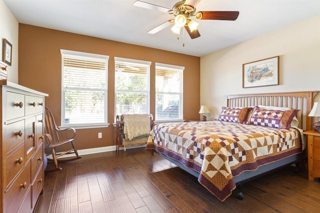 bedroom with dark hardwood / wood-style floors and ceiling fan