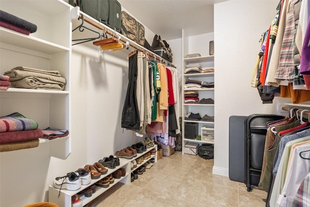 spacious closet featuring light tile patterned floors