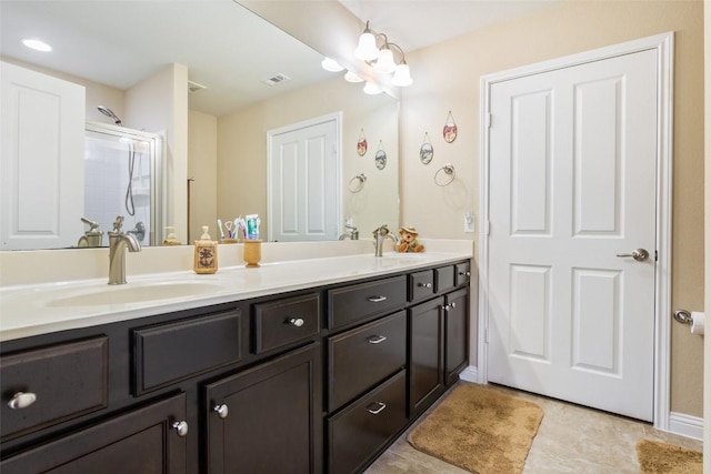 bathroom with vanity, a notable chandelier, tile patterned flooring, and an enclosed shower