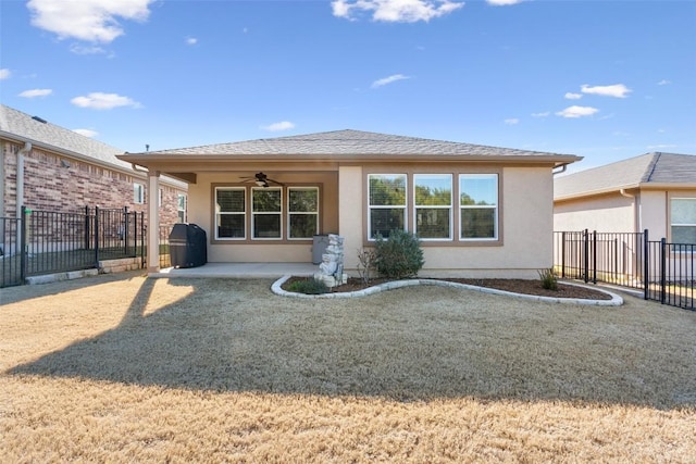 rear view of property with a patio and ceiling fan