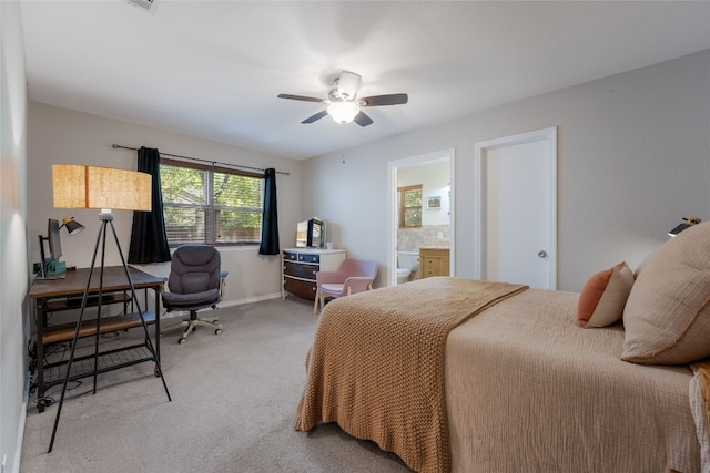 bedroom featuring ensuite bath, carpet floors, and ceiling fan