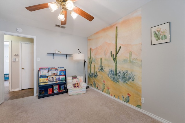 rec room with ceiling fan and light colored carpet