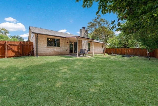 back of property featuring a lawn and a patio area