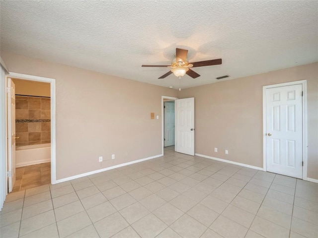 unfurnished bedroom featuring ceiling fan, a textured ceiling, and light tile patterned floors