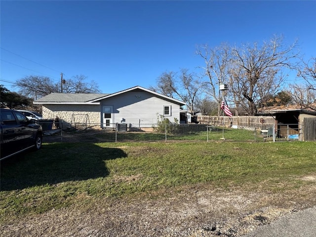 view of home's exterior with a lawn and fence