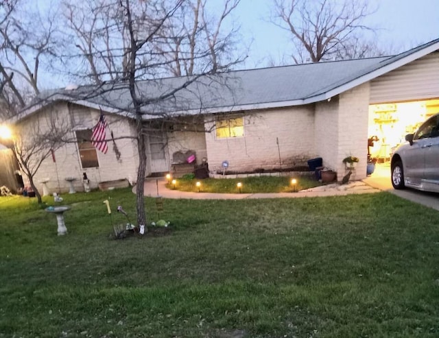 view of property exterior featuring a yard and brick siding