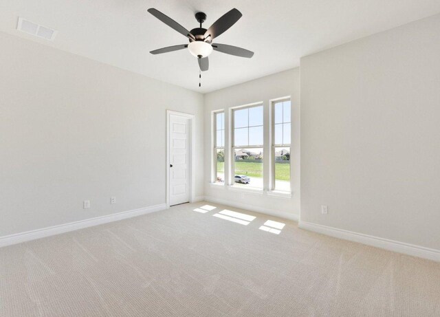 232 Flora Springs Cv, Liberty Hill, TX 78642 - empty room with carpet floors, baseboards, ceiling fan, and visible vents