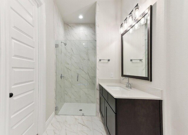232 Flora Springs Cv, Liberty Hill, TX 78642 - bathroom featuring a marble finish shower, recessed lighting, marble finish floor, and vanity