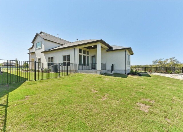 232 Flora Springs Cv, Liberty Hill, TX 78642 - back of house featuring a yard, fence, and stucco siding