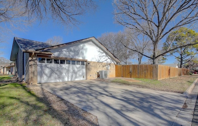 view of home's exterior featuring a garage and central air condition unit