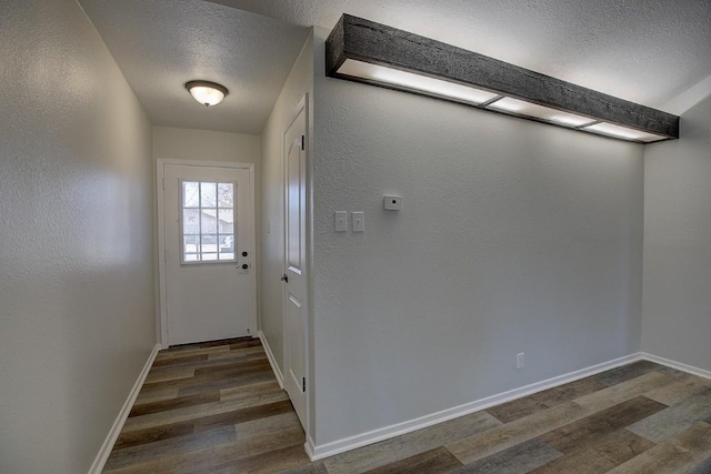 entryway with dark hardwood / wood-style floors and a textured ceiling