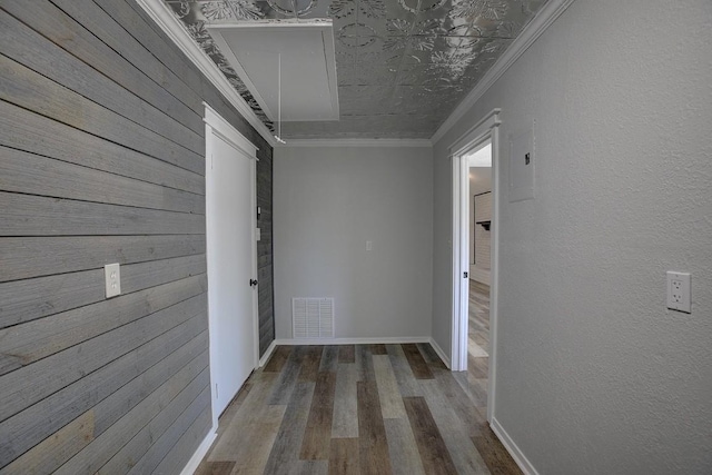 hallway with crown molding and hardwood / wood-style floors