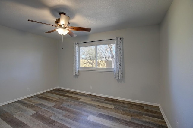 unfurnished room featuring dark hardwood / wood-style flooring, ceiling fan, and a textured ceiling