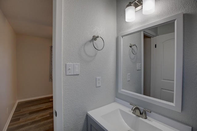 bathroom featuring hardwood / wood-style flooring and vanity