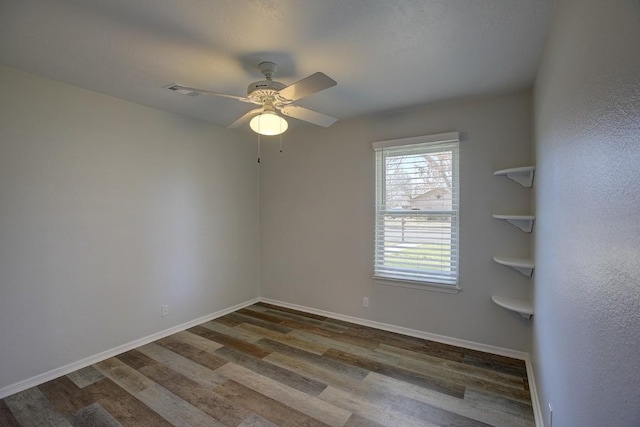 spare room featuring hardwood / wood-style flooring and ceiling fan