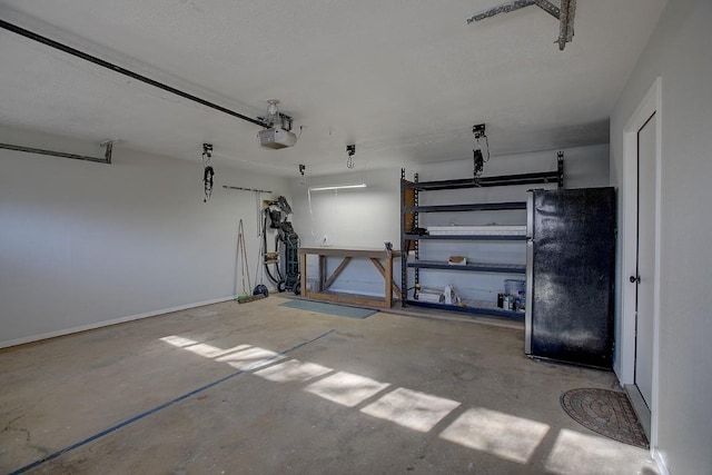 garage featuring a garage door opener and stainless steel refrigerator