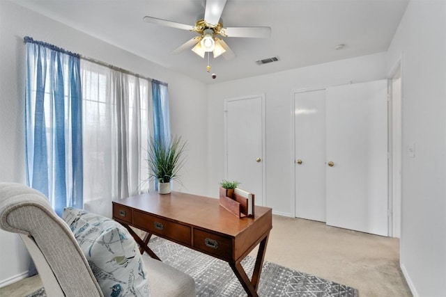 home office featuring light colored carpet and ceiling fan