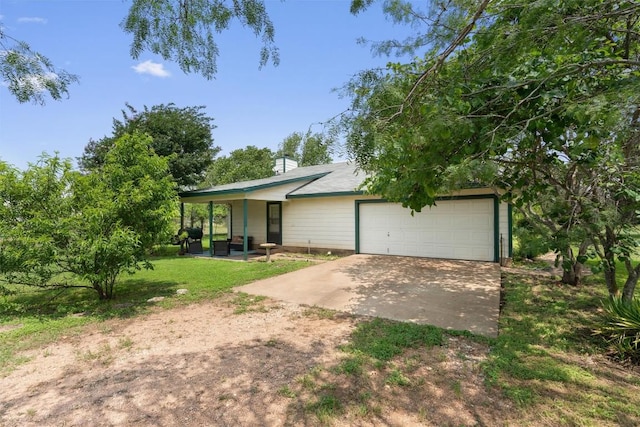 view of front of home with a garage and a front lawn