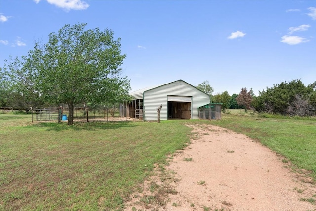 view of yard with an outbuilding and a rural view