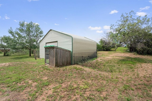 view of outbuilding featuring a yard