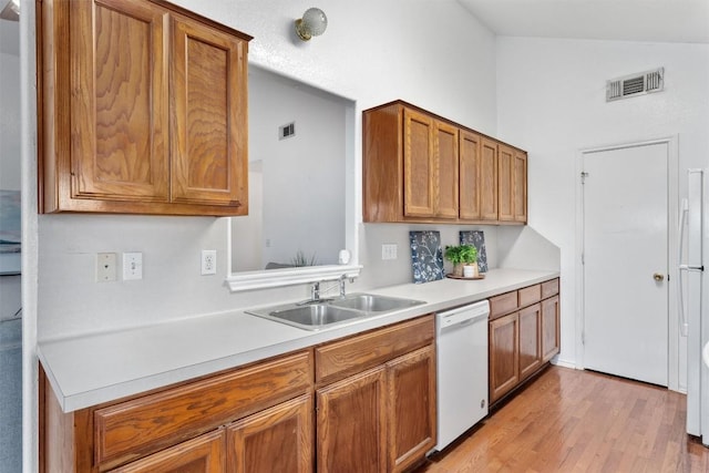 kitchen with sink, white dishwasher, and light hardwood / wood-style flooring