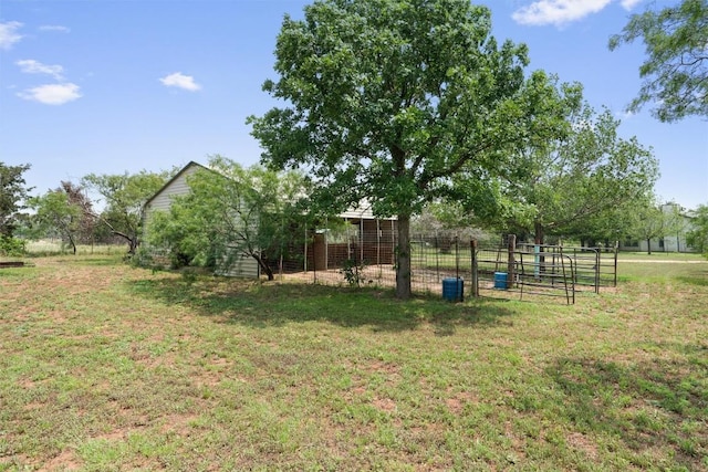 view of yard featuring an outdoor structure and a rural view