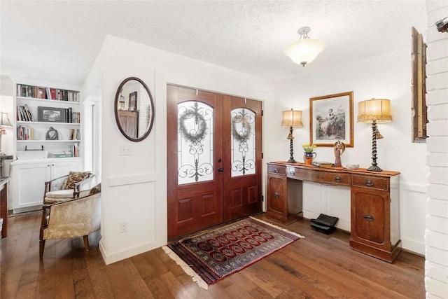 foyer with hardwood / wood-style flooring, french doors, and a textured ceiling