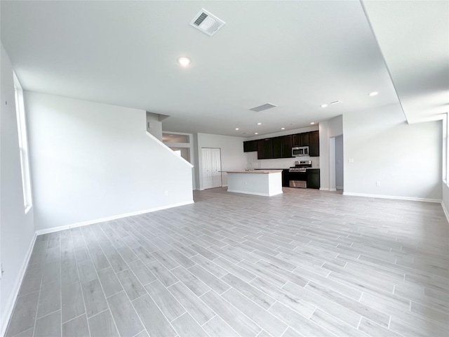 unfurnished living room featuring light wood-type flooring