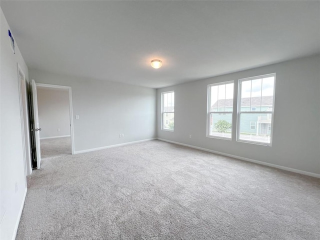 unfurnished room with light colored carpet