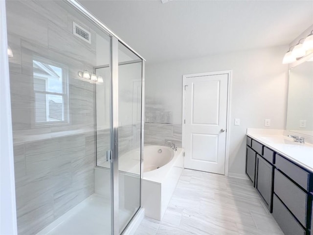 bathroom with independent shower and bath and vanity