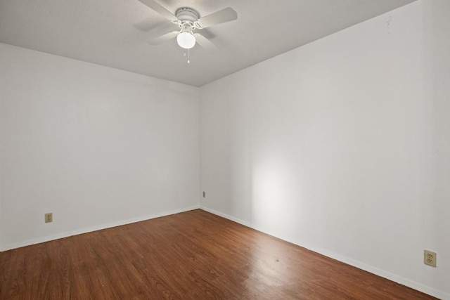 spare room featuring wood-type flooring and ceiling fan