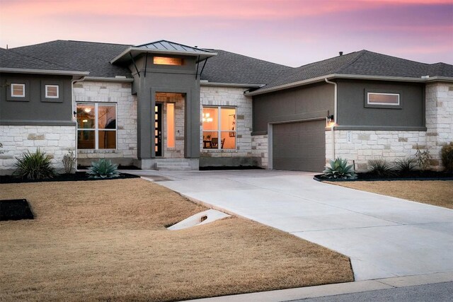 prairie-style home featuring a garage