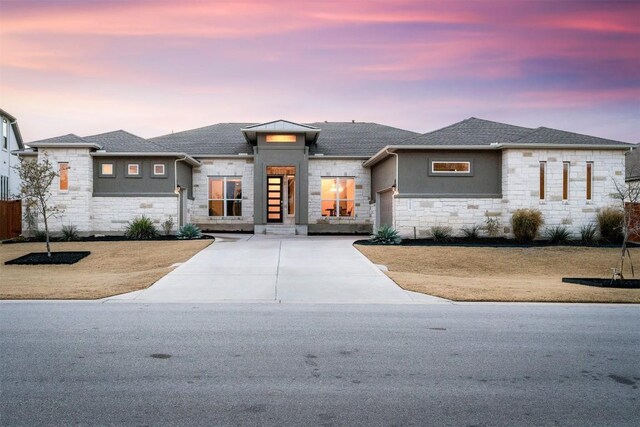 prairie-style home with a lawn