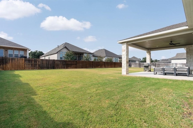 view of yard with ceiling fan, a patio, and a fenced backyard