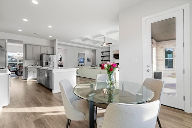 dining space featuring ceiling fan, recessed lighting, coffered ceiling, light wood-style floors, and beam ceiling