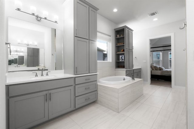 bathroom featuring vanity, tile patterned flooring, connected bathroom, and visible vents