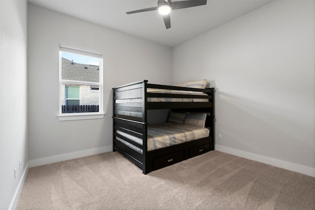 carpeted bedroom with ceiling fan and baseboards