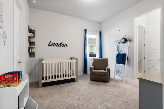 bedroom with light carpet, a nursery area, and baseboards