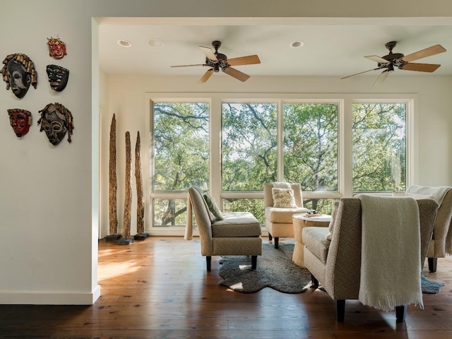 sunroom / solarium featuring ceiling fan and plenty of natural light