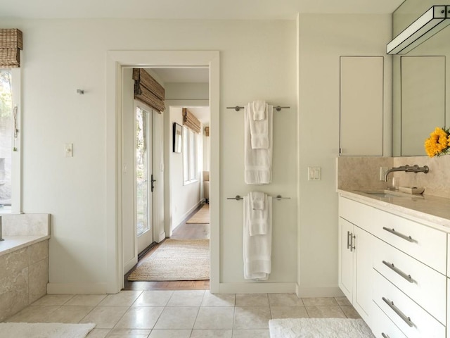 bathroom featuring tile patterned floors, vanity, and decorative backsplash