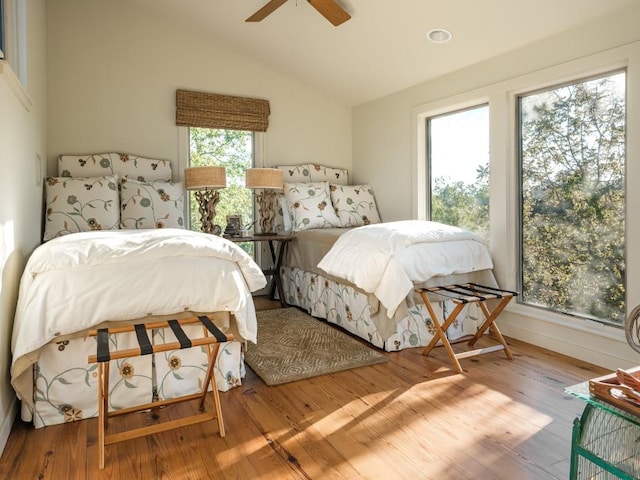 bedroom featuring ceiling fan, lofted ceiling, and light wood-type flooring