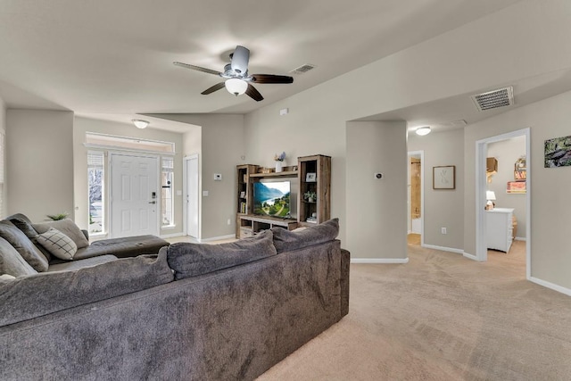 carpeted living room with ceiling fan